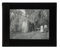 Lantern Slide #085: Couple outside palmetto house