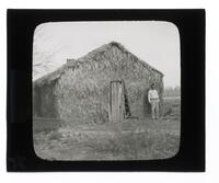 Lantern Slide #086: Man outside palmetto house