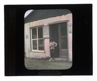 Lantern Slide #161: Boy in doorway, store, Loretteville, P.Q.