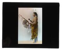 Lantern Slide #458: Native American man with rattle, pipe