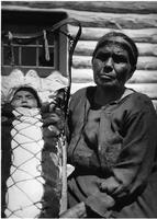 A015: Nancy Berens (Everett) and a grandchild in a mossbag and tikanagan, Berens River, Manitoba, circa 1930-1933