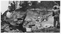 A049: En route on Berens River, one canoe load on rocks at portage, Manitoba, circa 1930s