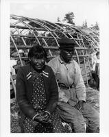 A119: Ojibwe man and woman in front of waabano lodge, Little Grand Rapids, Manitoba, circa 1930s