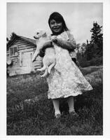 A024: Ojibwe girl with a puppy, Berens River, Manitoba, circa 1930-1933