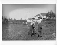 A130: Two Ojibwe boys shooting bows and arrows, Little Grand Rapids, Manitoba, circa 1930s