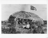 A202: A'aasii, Margaret Pascal (Tekis), and an Ojibwe girl in front of waabano lodge, Pauingassi, Manitoba, circa 1933