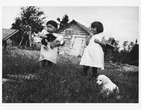 A025: Ojibwe boy and girl with puppies and kitten, Berens River, Manitoba, circa 1930-1933