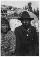 A135: John Leveque (Shinishkaank) and his wife Waaphishiink, in front of waabano lodge, Little Grand Rapids, Manitoba, circa 1930s