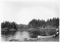 A050: Two Ojibwe men with canoe at rest, en route on Berens River, between Berens River and Little Grand Rapids, Manitoba, circa 1930s