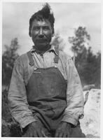 A132: Alexander Bushie (Noojibine), seated outside, Little Grand Rapids, Manitoba, circa 1930s