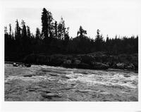 A071: En route on Berens River, canoe shooting rapids, Manitoba, circa 1930s