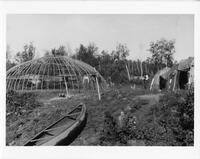 A242: Boodaadewigamig, Dream Drum lodge, tent structure, and canoe, Poplar Hill, Ontario, circa 1930s