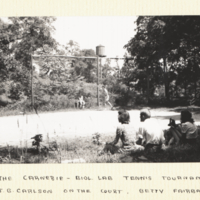 The Carnegie Biol. Lab Tennis Tournament -- Dr. J. G. Carlson on the Court, Betty Fairbanks and Jim Neel on the Sidelines.