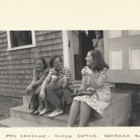 Mrs. Sansome, Eillen Sutton, Barbara Korsch sitting on steps outside of building.