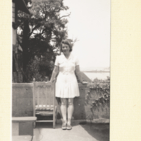 Dorothy Wrinch standing near low fence.