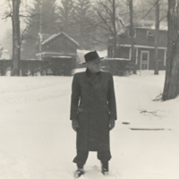 Dr. Andre Dryfuss standing outside in snow, full length portrait.