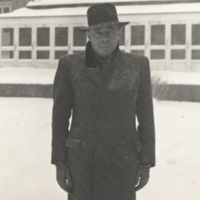 Dr. Andre Dreyfuss, standing outside in snow, 3/4 length portrait.