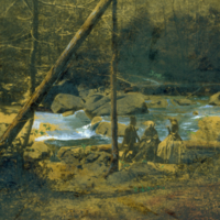 Three people beside a creek