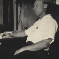 Sam Pond seated at desk.