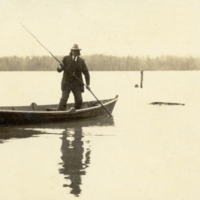 8-1-m: Pamunkey fisherman poling boat to visit set-lines, swamp hunting grounds in background.