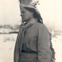 9-17-w: Man with ceremonial headdress and cuffs.