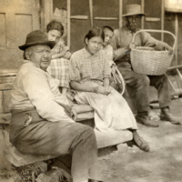 9-9-a: Penobscot men and women, seated outside.