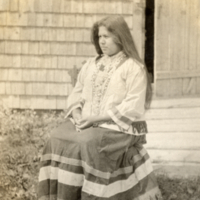 9-8-s: Penobscot woman, seated outside.