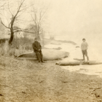 9-7-m: Man and boy with canoe (turned over).