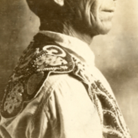 9-8-m: Peter Nelson wearing ceremonial collar, profile.