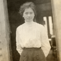 9-11-f: Young woman standing in doorway.