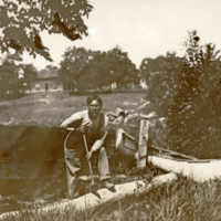 9-9-e: Young man with a canoe.