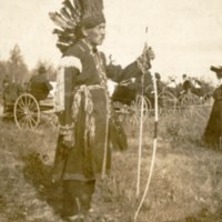 9-12-n: Tomah Joseph in ceremonial attire with bow.