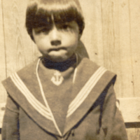 9-7-d: Penobscot child, standing outside.