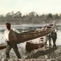 Penobscot men carrying canoe