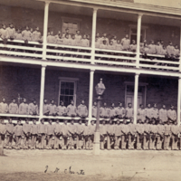 Indian boys (from 16 different tribes) at the Indian Training School, April 20th 1880. (The ranks on the ground and lower porch show the same Sioux boys who appear in [image 3b]).