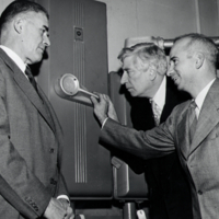 W. F. G. Swann, with two other men, inspecting equipment.