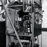 Two unidentified men, standing beside scientific equipment.