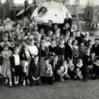 Group portrait of children in front of Piccard Stratosphere Flight vessel.