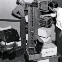 W. F. G. Swann and unidentified man working with scientific equipment.