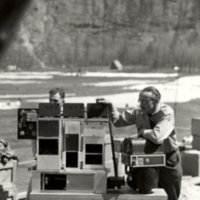 View of men working on scientific equipment for stratospheric flight.