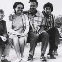 Medvedev with woman and two young men [family?], seated on bench.