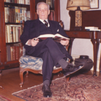 William Ezra Lingelbach, seated, holding open book.