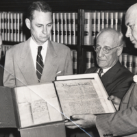 William Ezra Lingelbach, standing, half length, with three unidentified men looking at a Benjamin Franklin manuscript, informal.