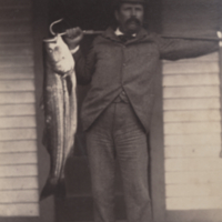 Man standing on porch, 'a true'fish-story'.