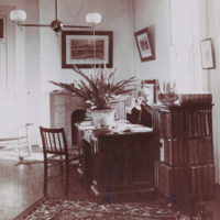 William Thomas Councilman, bust, informal, sitting at desk in study smoking pipe.