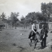 Helen Thomas Flexner riding a donkey outside of the Ming Tombs, Peking.