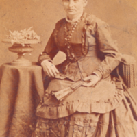 Ester Abraham Flexner seated near small table.