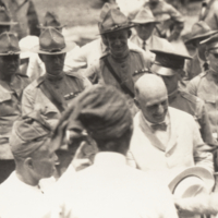 W. Cameron Forbes (?) shaking hands with unidentified man in crowd.