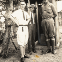 Heiser and two unidentified men standing outside.