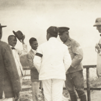 Heiser and Gen. Wood being greeted by a group of unidentified men.